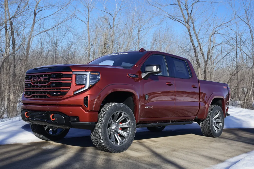 gmc-1500-m80-red-driver-quarter-front-low