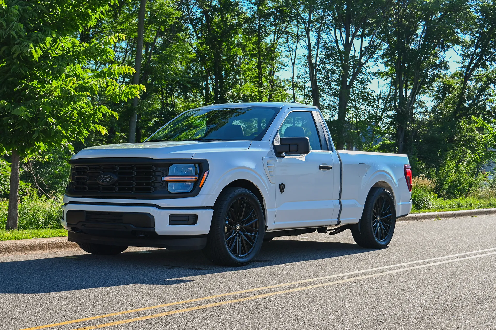 redline-f150-white-2026-reg-cab-side-driver-low-angle